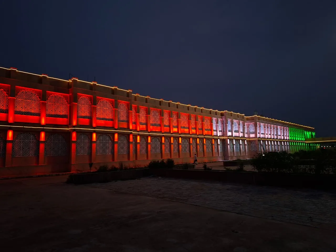 Himmatnagar railway station facade with arched jali screens lit in warm amber at night (2 of 3)