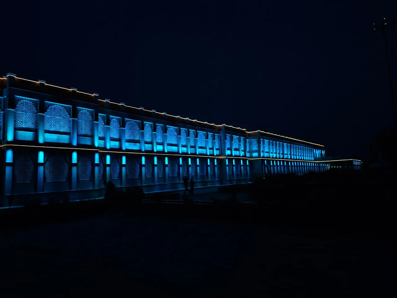 Himmatnagar railway station facade with arched jali screens lit in warm amber at night (3 of 3)